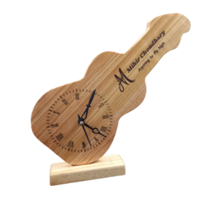 Handcrafted guitar-shaped wooden wall clock made from natural pine with gold hands, minimalist home decor