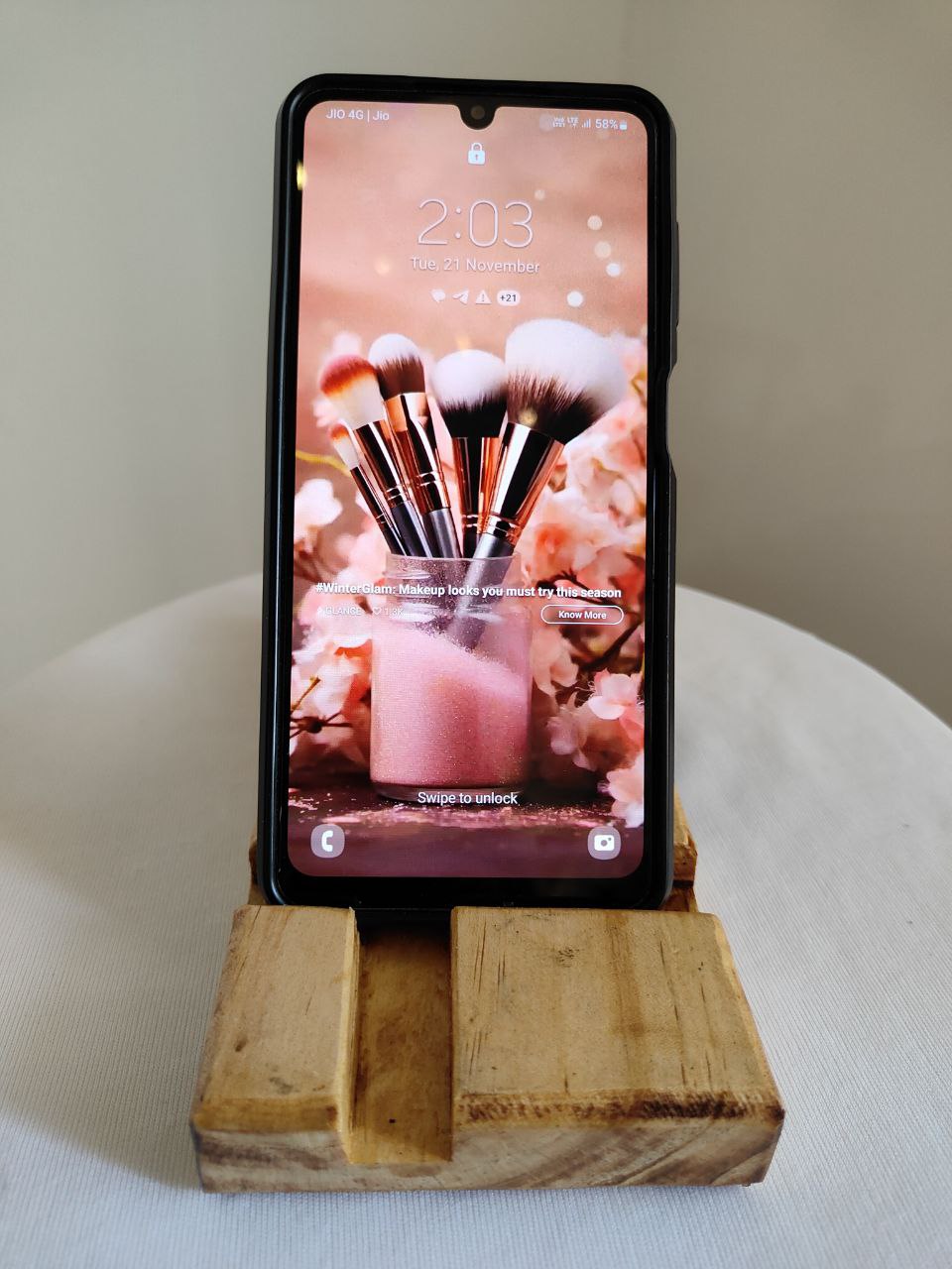 A polished light-grain wooden desk organizer and phone stand with the "Transcento Decor" logo engraved, isolated on a white background.