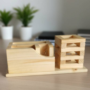 Natural pine wood desk organizer with a vertical smartphone stand, two pen holder slots, and a small stationery tray.